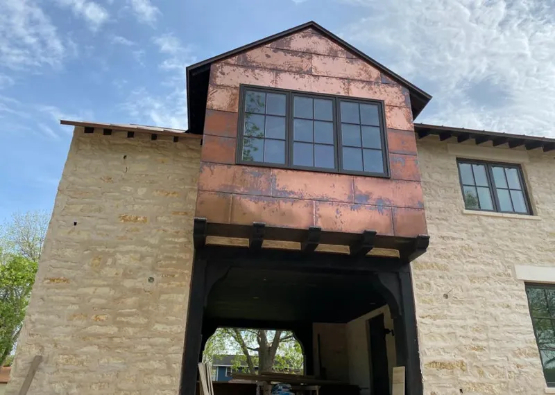 Copper metal panel facade on a stone building for Roof Repair in Running Springs